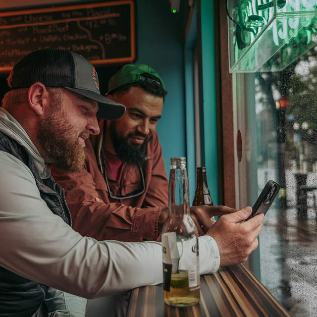 2 men planning fishing over a beer